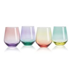 four different colored wine glasses sitting next to each other