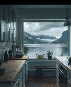 a kitchen filled with lots of counter top space next to a large window covered in snow