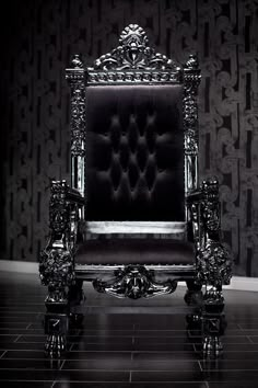 a black and white photo of an ornate chair