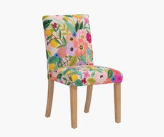 an upholstered chair with floral fabric and wooden legs