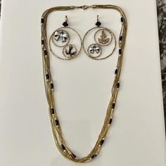 This is a darling summer-time matching necklace and earring set! Gold multi-strand necklace with small navy beads and white pearls. Gold hoop earrings with smaller hoops within that have white/navy bows, rhinestone anchor, and navy bird. Lightweight - in GREAT wearable condition! Dress up a plain white shirt with just these few pieces! Happy to bundle with my other listings. Make an offer. Message me. Thank you and happy looking! Lot 145 Plain White Shirt, Sailor Bow, Navy Sailor, Anchor Necklace, Necklace And Earring Set, Multi Strand Necklace, Matching Necklaces, Necklace Earring Set, Gold Hoop Earrings