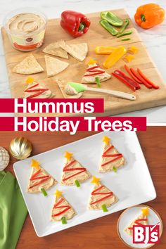 hummus holiday trees on a cutting board with crackers and peppers in the background