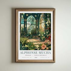 a framed poster hangs on the wall next to a potted plant and flowers in front of a window