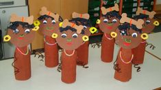 paper mache puppets made to look like children's faces and hair on sticks