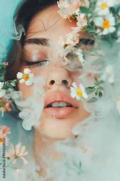 a woman with flowers in her hair and eyes is surrounded by white daisols