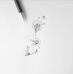 a pencil drawing of a rose with stars and moon in the sky on paper next to a pen