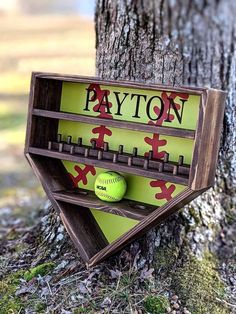 a wooden sign that says payton with a baseball in the middle and softball on top