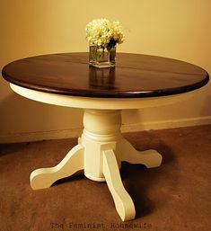 a white and brown table with flowers on top