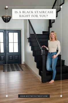 Whitney standing in front of a black staircase Black Wood Stair Railing, Dark Staircase Ideas, Black Railing Stairs, Black Banister, Painted Wood Stairs, Dark Staircase, Wood Railings For Stairs