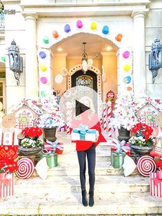 a woman standing in front of a building with candy canes