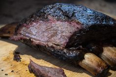 a piece of meat sitting on top of a wooden cutting board