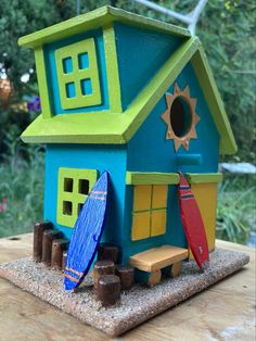 a toy house with surfboards on the table