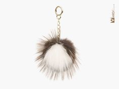 a white and brown fur ball keychain