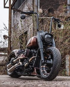 a black and brown motorcycle parked in front of a building