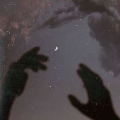 two hands reaching up towards the sky with clouds and moon in the backgroud