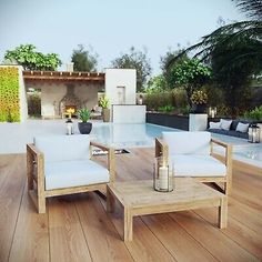 two chairs and a coffee table on a wooden deck next to an outdoor swimming pool