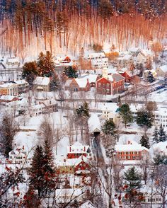 an aerial view of a small town in the snow