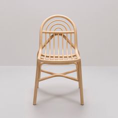 a wooden chair sitting on top of a white floor