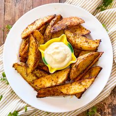 yummy deluxe potatoes with garlic sauce on a white plate