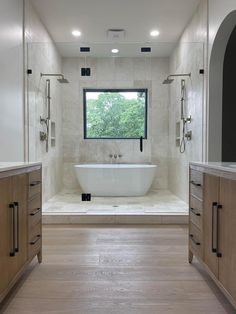 a large white bath tub sitting under a window