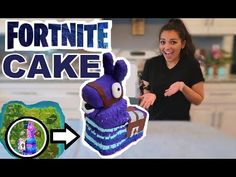 a woman standing in front of a cake that is shaped like an egg and has the words fortnite cake on it