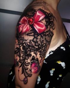 woman's half sleeved tattoo with lace and red bow