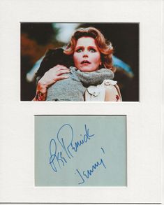 an autographed photograph of a woman with her arm around another woman's shoulder