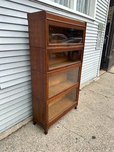 a wooden shelf sitting on the side of a house