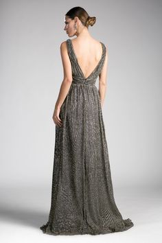 the back of a woman wearing a long dress with an open neckline and straps