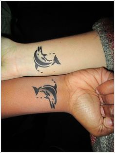 two people with matching tattoos on their arms