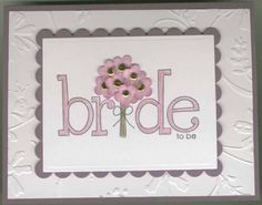 a white card with pink flowers and the words bride to be written in gold on it