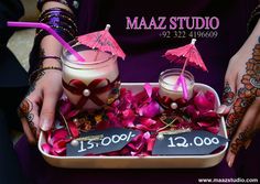 a tray with two drinks in it and pink flowers on the bottom one is labeled maaz studio