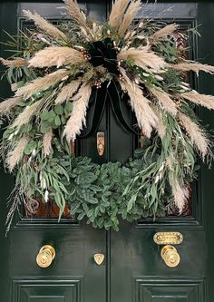 a green door with a wreath on it