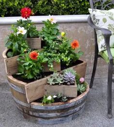 an outdoor patio area with potted plants in wooden planters on the ground and a chair next to it