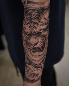 a man with a tiger tattoo on his arm