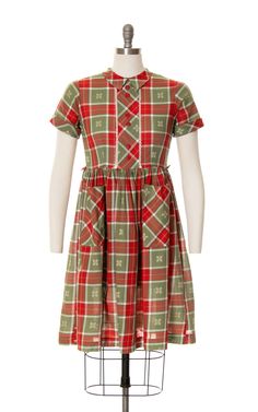 "♡ PLEASE ENLARGE PHOTOS FOR MORE DETAIL ♡ D E T A I L S * 1950s dress * fit + flare shape * cotton * plaid * red, green, white, yellow * pointed peter pan collar * lace trim * decorative buttons down front * short cuffed sleeves * fitted waist + belt loops * gathered full skirt * two big patch pockets * button closures up back; fixed waist * unlined * label: Honeylane M E A S U R E M E N T S fits like a: petite small (or babydoll look with empire waist) shoulders: 13.5\" bust: 37\" waist: 32\" 1950s Collared Daywear Dresses, 1950s Collared Day Dresses, Red Short Sleeve Dress For Vintage Fashion, Vintage Red Dress With Buttons, Red Vintage Dress With Buttons, Red Vintage Fashion Dress With Short Sleeves, Vintage Red Dresses With Buttons, Red Vintage Dresses With Buttons, Red Short Sleeve Vintage Dress