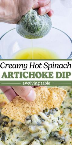 a hand dipping a tortilla chip into a glass bowl filled with artichoke dip