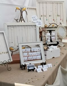 a table topped with lots of different types of boxes and frames next to each other