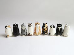 a group of small figurines sitting next to each other on a white surface