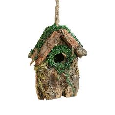 a birdhouse hanging from a rope on a white background