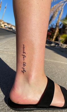 a woman's foot with a tattoo that says, i am not afraid to fly