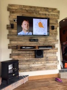 a tv mounted to the side of a wooden wall