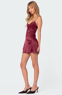 Date night is calling in this satiny mini designed with a lace-trimmed neckline and a strappy open back. Ties at back V-neck Sleeveless 95% polyester, 5% spandex Machine wash, dry flat Imported Little Red Dress Formal, Affordable Romantic Mini Dress With Spaghetti Straps, City Nights Dress, Small Christmas Dresses, Little Red Dress Silk, Tight Fancy Dresses Short, Maroon Bodycon Short Dress, Satin Prom Dress Mini, Cheap Mini Dress With Strappy Details