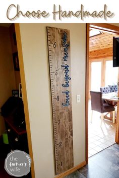 a large wooden ruler hanging on the wall next to a door with words that read choose handmade