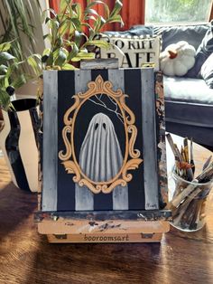 a wooden box with an image of a ghost in it on top of a table