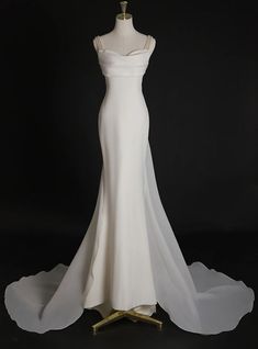 a white wedding dress on a mannequin