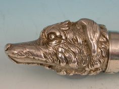 a close up of a metal object with a dog's head on it