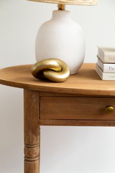 a table with two books and a lamp on it