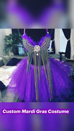 a purple dress with beads on it and the words custom mardi gras costume