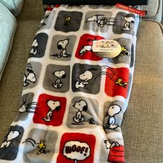 the blanket is made to look like it has peanuts on it and red, white, and gray squares